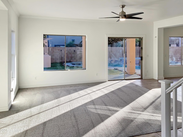 interior space featuring light colored carpet, ceiling fan, and ornamental molding