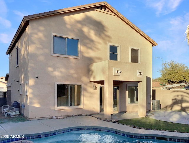 back of house featuring a patio area and central air condition unit