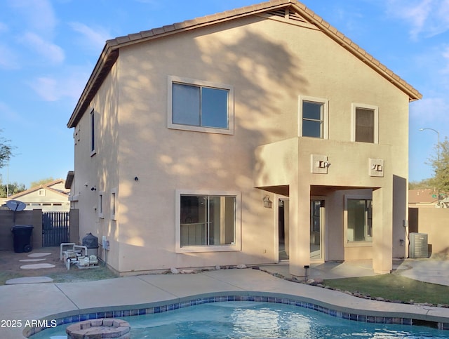 back of house featuring cooling unit and a patio