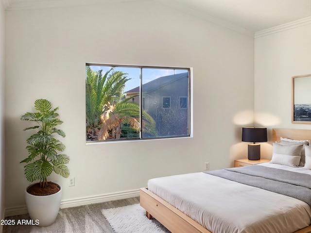 bedroom with hardwood / wood-style floors and ornamental molding