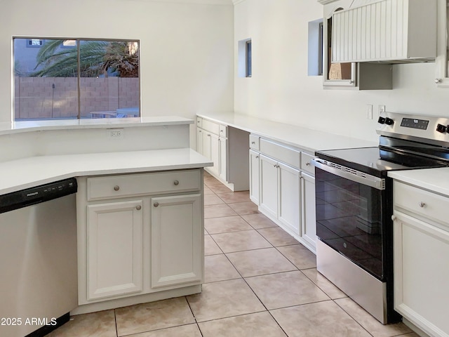 kitchen with appliances with stainless steel finishes, ventilation hood, and white cabinetry