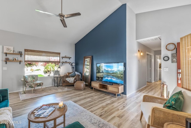 living room with ceiling fan, high vaulted ceiling, wood finished floors, and baseboards