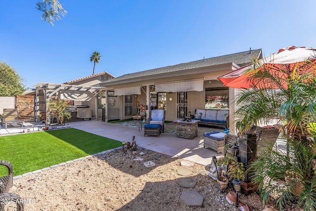 back of house featuring a patio area, a lawn, an outdoor hangout area, and stucco siding