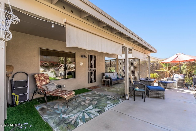 view of patio with fence and an outdoor hangout area