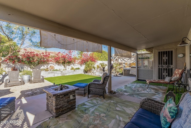 view of patio featuring an outdoor fire pit and a fenced backyard