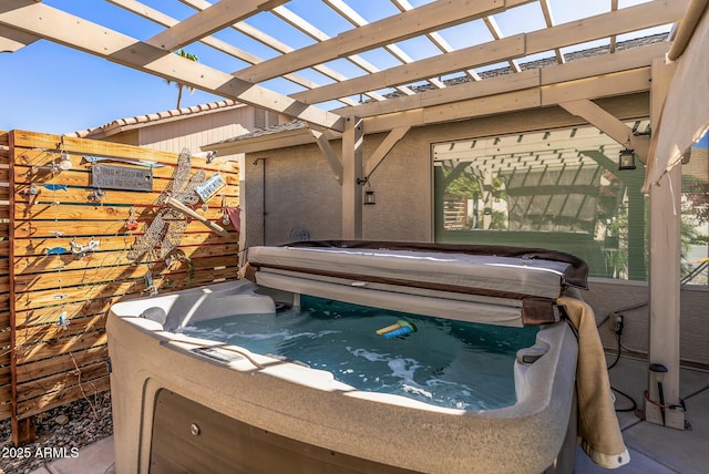 view of patio / terrace with a pergola and a hot tub