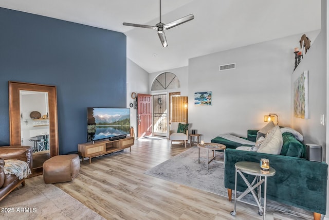 living room with high vaulted ceiling, ceiling fan, visible vents, and wood finished floors