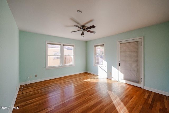 empty room featuring hardwood / wood-style flooring and ceiling fan