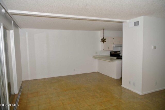 interior space with pendant lighting, white cabinets, a textured ceiling, electric range oven, and a chandelier