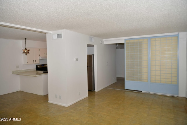 empty room with a textured ceiling