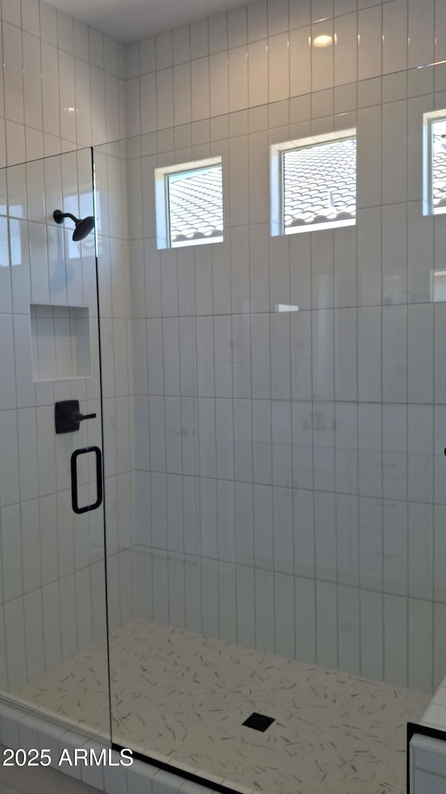 full bath featuring a stall shower and a wealth of natural light