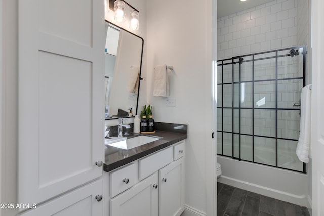 3281 Maverick Dr, Wickenburg, AZ 85390 - bathroom featuring combined bath / shower with glass door, vanity, toilet, and wood tiled floor