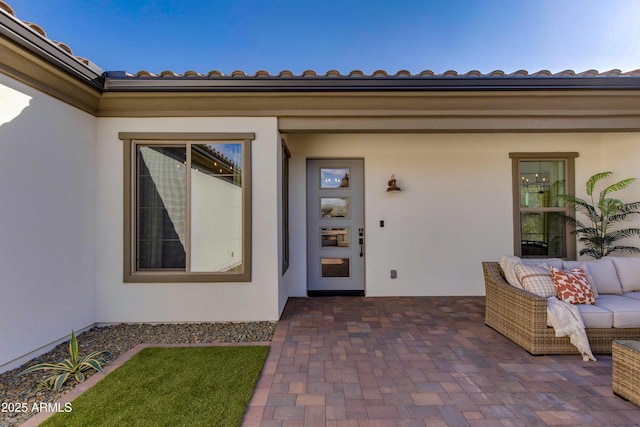 3281 Maverick Dr, Wickenburg, AZ 85390 - doorway to property featuring stucco siding, a tiled roof, outdoor lounge area, and a patio area