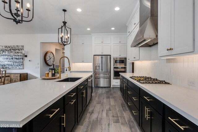 3281 Maverick Dr, Wickenburg, AZ 85390 - kitchen with a sink, stainless steel appliances, wall chimney exhaust hood, and a chandelier