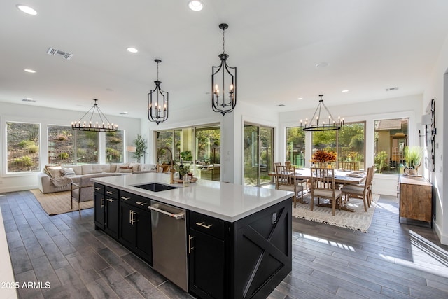 3281 Maverick Dr, Wickenburg, AZ 85390 - kitchen with a sink, dishwasher, wood tiled floor, dark cabinets, and an inviting chandelier