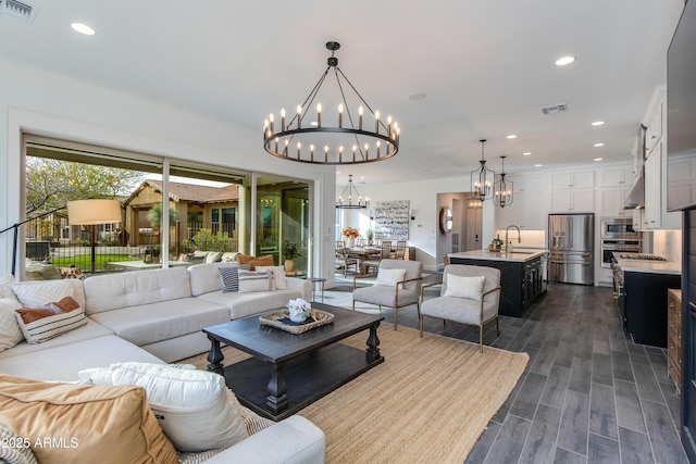 3281 Maverick Dr, Wickenburg, AZ 85390 - living area with visible vents, recessed lighting, dark wood-type flooring, and an inviting chandelier