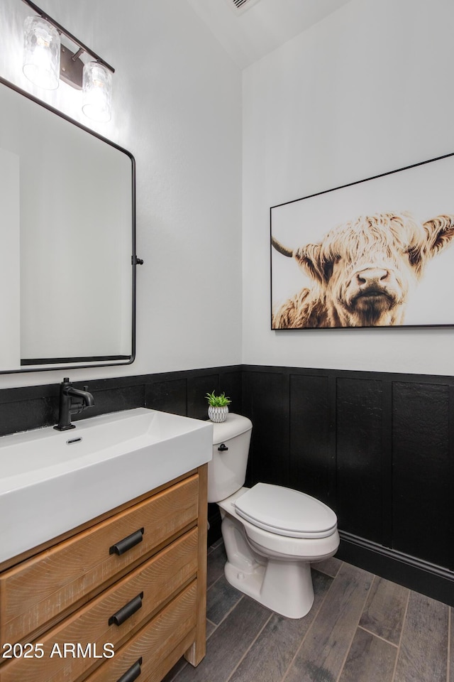 3281 Maverick Dr, Wickenburg, AZ 85390 - bathroom with a wainscoted wall, toilet, vanity, and wood finished floors