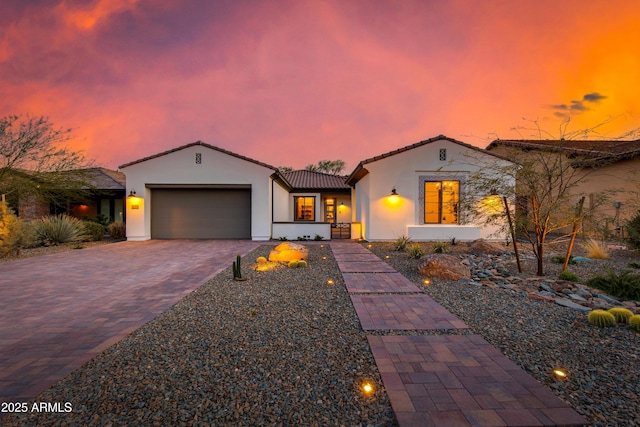3281 Maverick Dr, Wickenburg, AZ 85390 - mediterranean / spanish house with stucco siding, a garage, a tiled roof, and decorative driveway