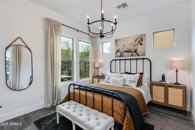 3281 Maverick Dr, Wickenburg, AZ 85390 - bedroom featuring wood tiled floor, visible vents, baseboards, and an inviting chandelier