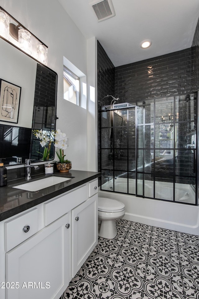 3281 Maverick Dr, Wickenburg, AZ 85390 - full bathroom featuring shower / bath combination with glass door, vanity, toilet, tile patterned floors, and visible vents
