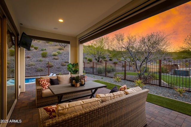 3281 Maverick Dr, Wickenburg, AZ 85390 - patio terrace at dusk featuring an outdoor living space and fence