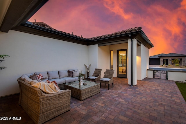 3281 Maverick Dr, Wickenburg, AZ 85390 - patio terrace at dusk featuring an outdoor hangout area