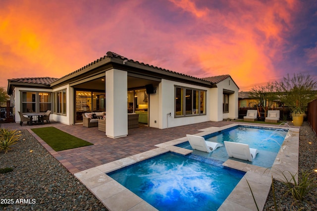 3281 Maverick Dr, Wickenburg, AZ 85390 - back of house at dusk with outdoor lounge area, a patio area, a tiled roof, and an in ground hot tub
