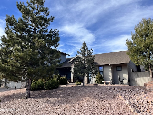 view of front of home featuring fence