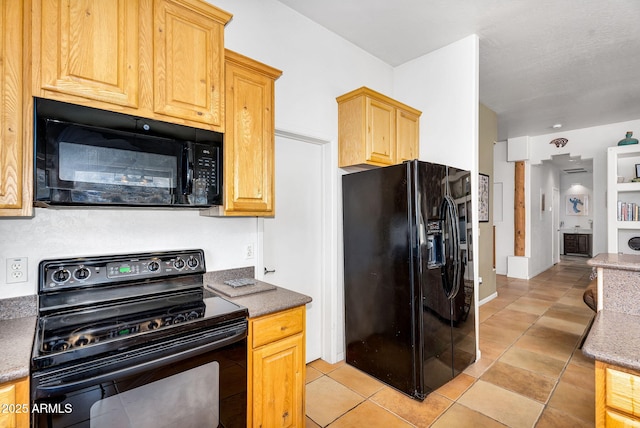 kitchen with black appliances and light tile patterned floors