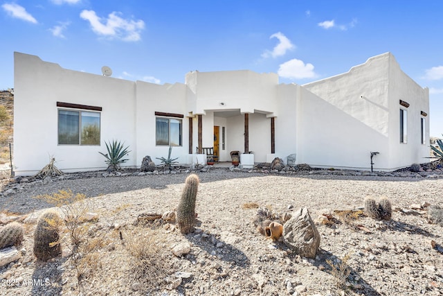 pueblo-style house with stucco siding