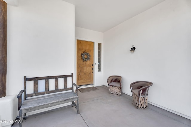 entrance to property featuring stucco siding