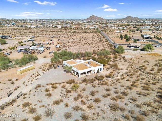 birds eye view of property featuring a desert view and a mountain view