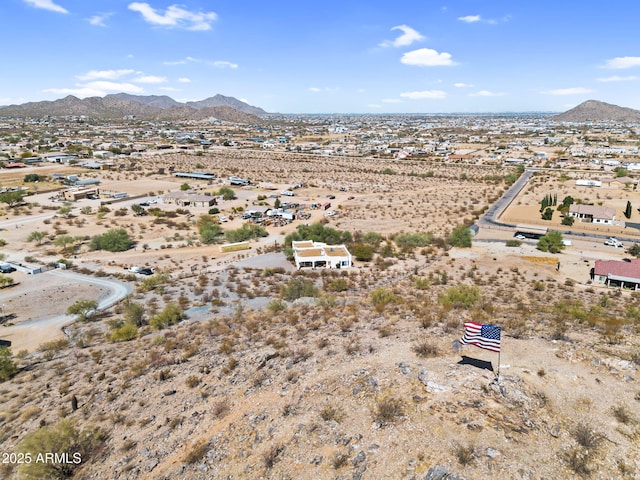 drone / aerial view featuring a mountain view and view of desert