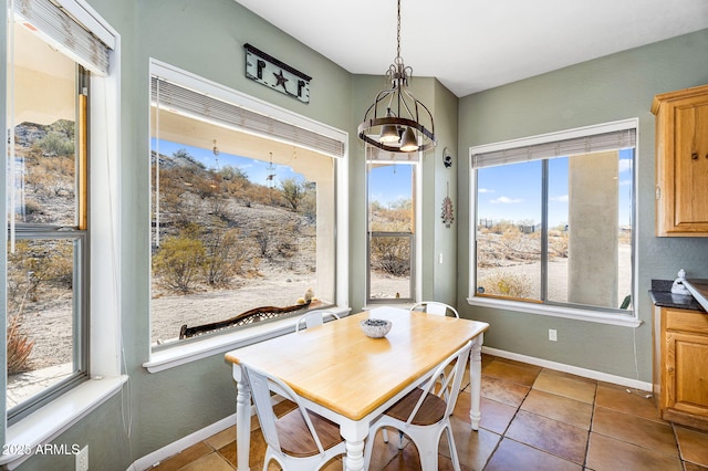 dining room featuring tile patterned flooring and baseboards