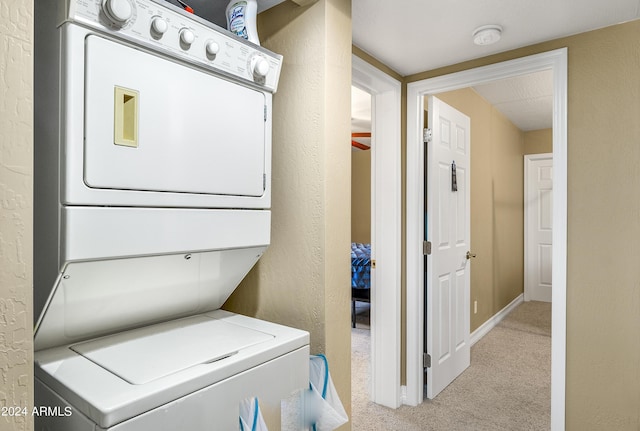 4371 E Savannah Cir, Flagstaff, AZ 86004 - laundry room with carpet flooring, a textured wall, baseboards, stacked washing maching and dryer, and laundry area