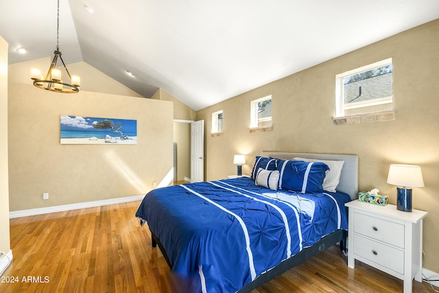 4371 E Savannah Cir, Flagstaff, AZ 86004 - bedroom featuring wood finished floors, a chandelier, vaulted ceiling, and multiple windows