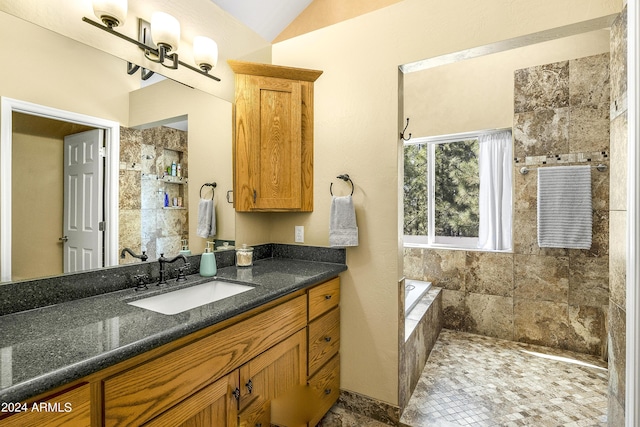 4371 E Savannah Cir, Flagstaff, AZ 86004 - bathroom featuring a tile shower, lofted ceiling, and vanity