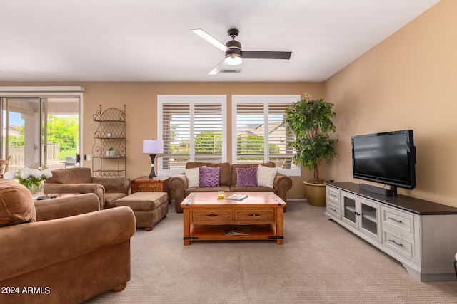 carpeted living room featuring ceiling fan