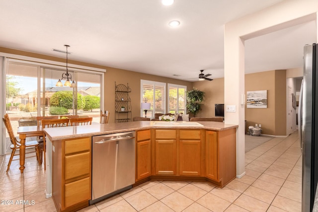 kitchen featuring stainless steel appliances, light tile patterned flooring, a sink, and a ceiling fan