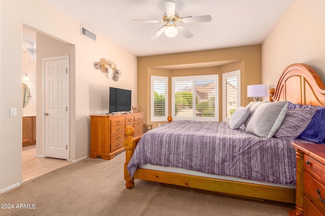 bedroom featuring light carpet, ceiling fan, visible vents, and baseboards