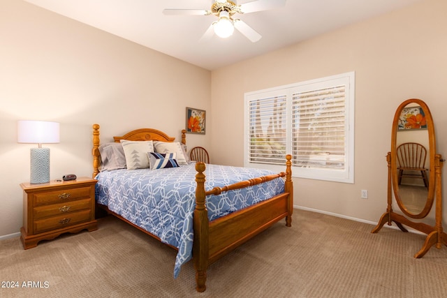 bedroom featuring light carpet, baseboards, and a ceiling fan