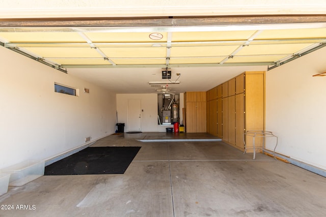 garage featuring a garage door opener and heating unit