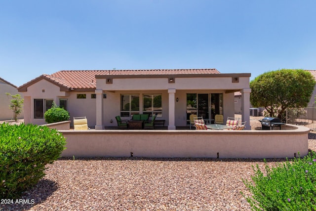 back of property featuring a patio area, a tiled roof, fence, and stucco siding