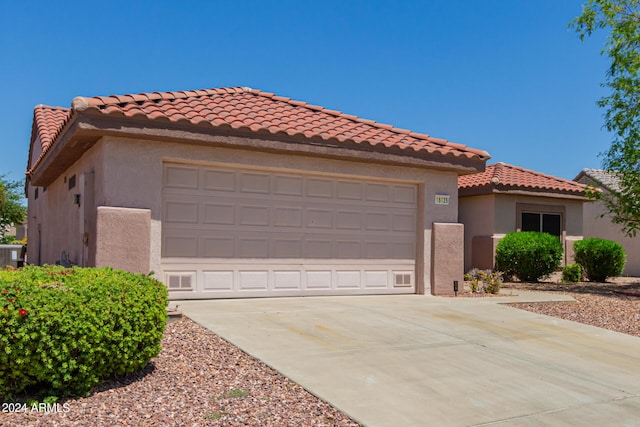 view of front of home featuring a garage and cooling unit