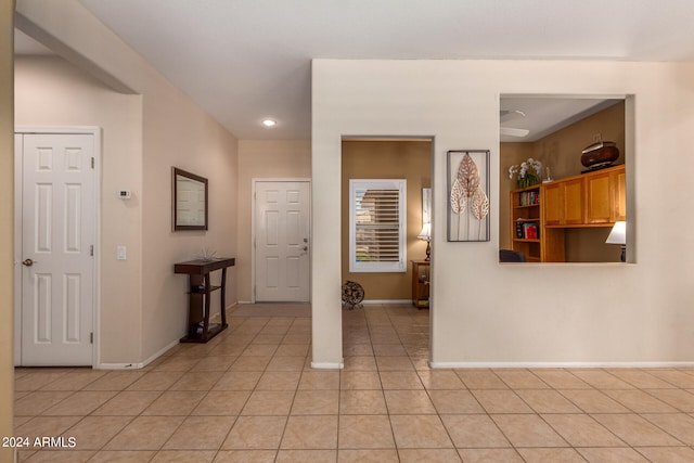 hall featuring light tile patterned flooring