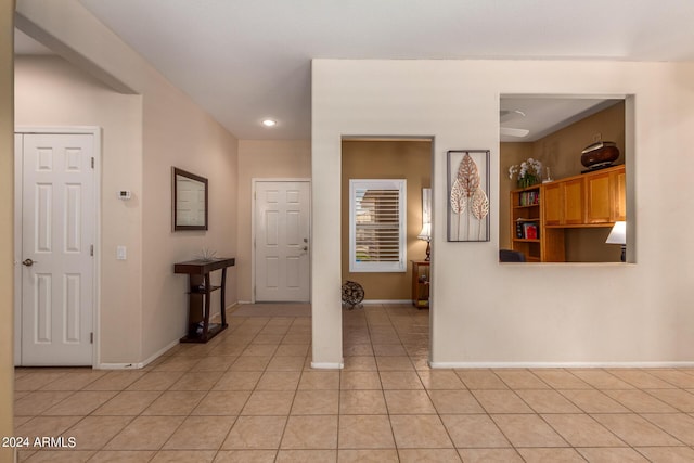 foyer featuring light tile patterned floors and baseboards