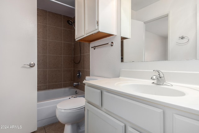 full bathroom with tile patterned flooring, toilet, tiled shower / bath combo, and vanity