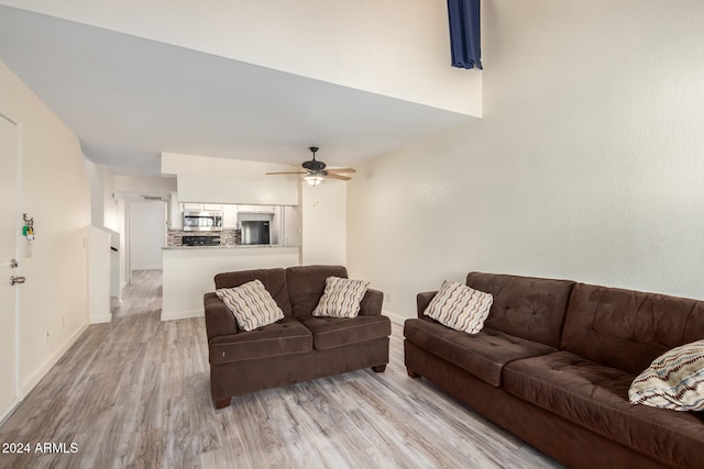 living room featuring light wood-type flooring and ceiling fan