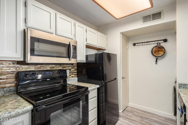 kitchen featuring white cabinets, black appliances, backsplash, and light hardwood / wood-style floors