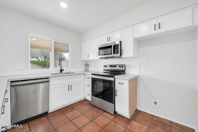 6527 W Sunnyside Dr, Glendale, AZ 85304 - kitchen featuring light countertops, white cabinetry, decorative backsplash, stainless steel appliances, and a sink